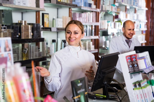 pharmacists standing with a cash desk