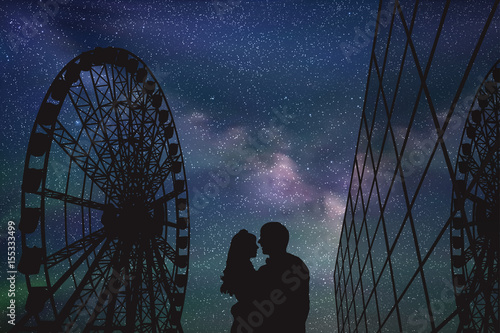 Lovers in amusement park at night. Vector illustration with silhouette of loving couple under starry sky. Ferris wheel and glass building