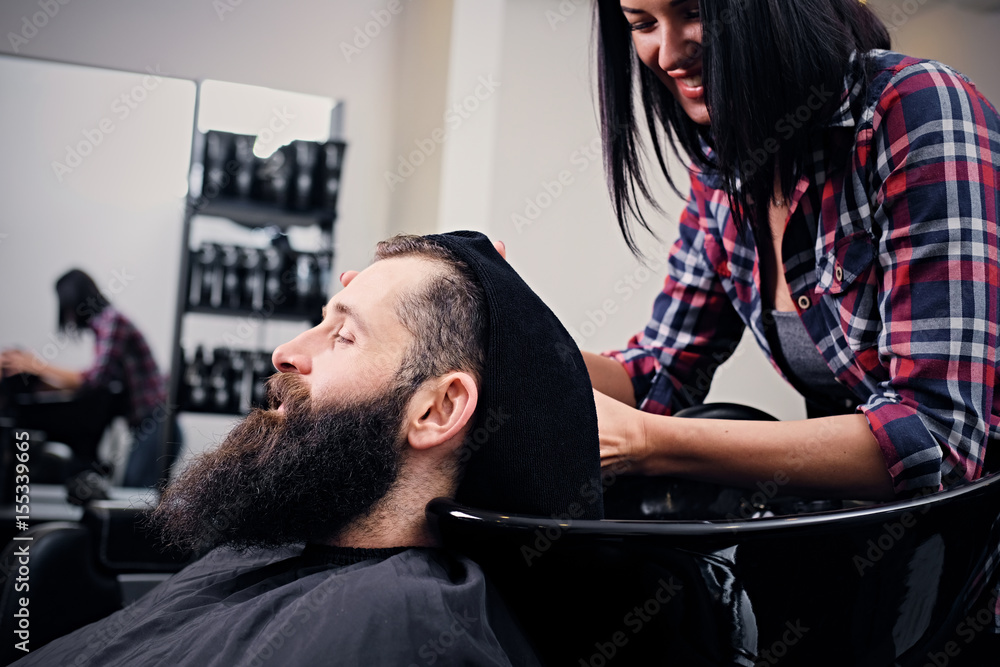 Hairdresser washing bearded men's hair. Hairdresser washing bearded men's hair.