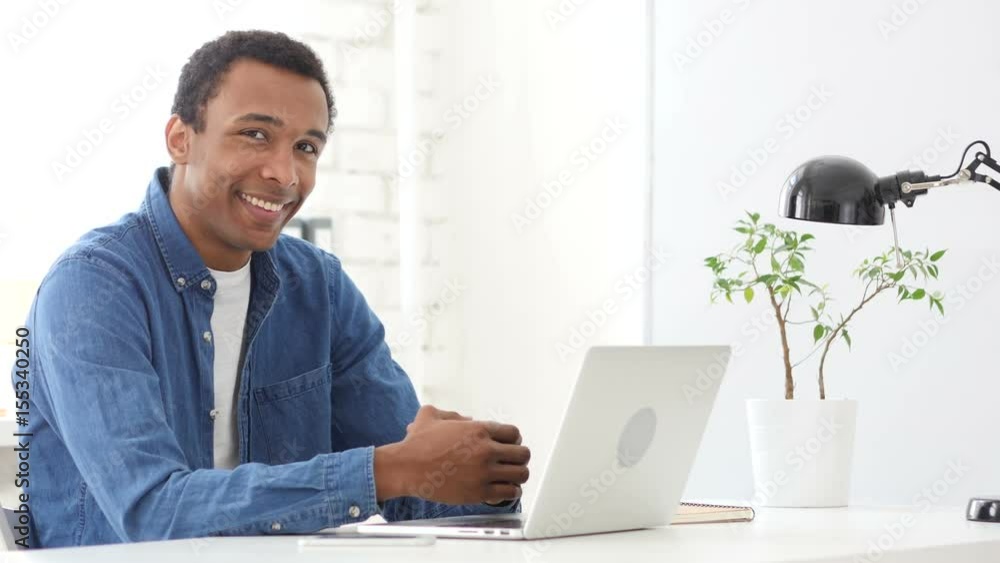 Afro-American Man at Work Smiling toward Camera Afro-American Man at Work Smiling toward Camera