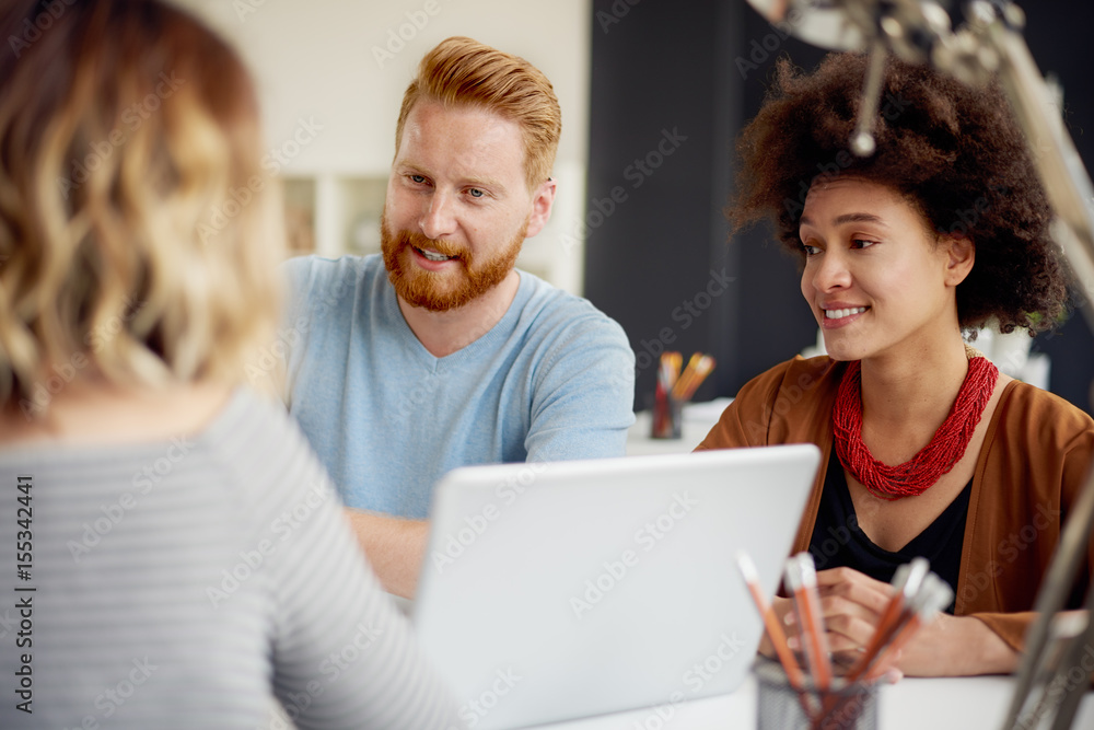 Multi-ethnic group having a meeting or presentation in modern office Multi-ethnic group having a meeting or presentation in modern office