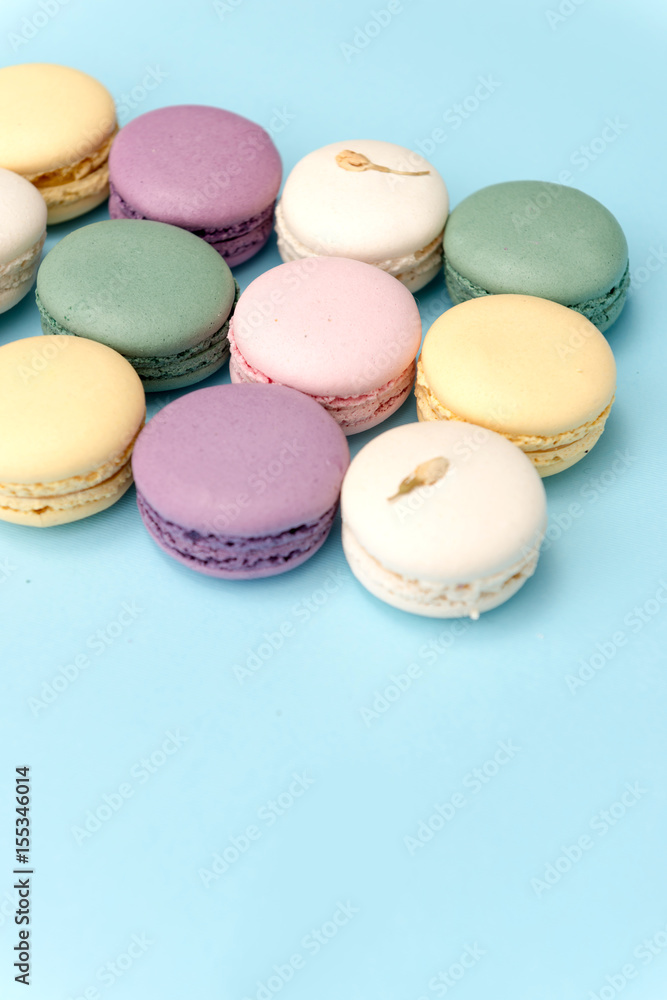 Sweet colorful macaroons on blue table background. Sweet colorful macaroons on blue table background.
