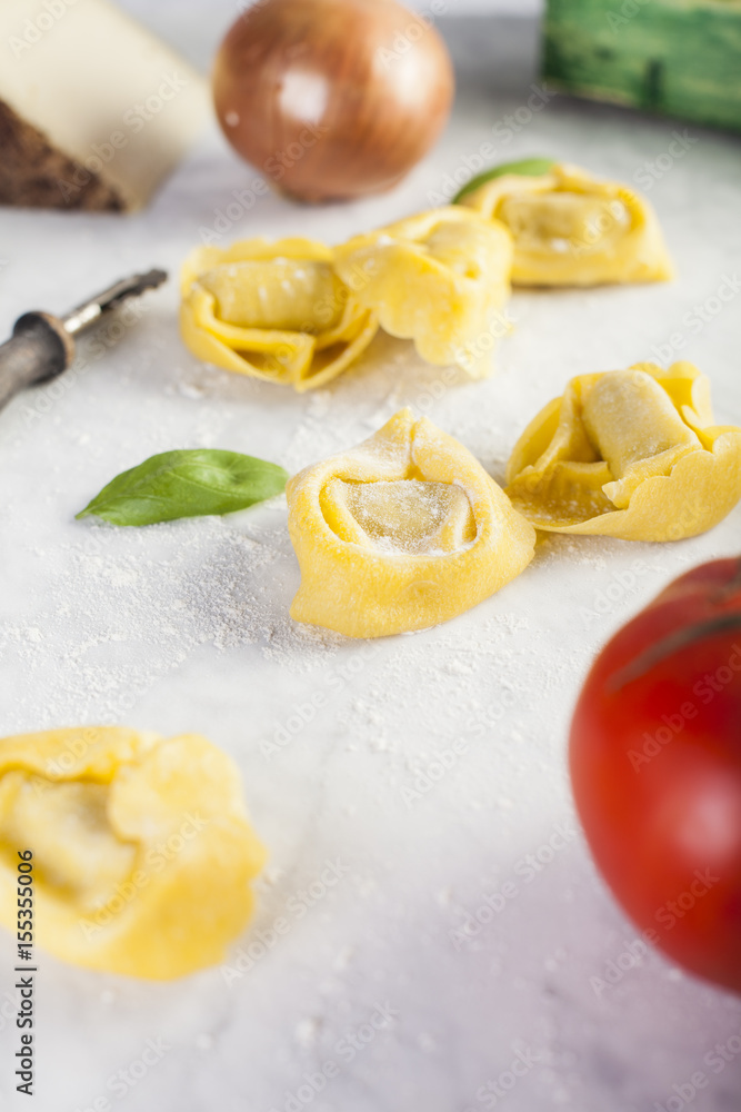 Raw and fresh big tortellini in a marble table Raw and fresh big tortellini in a marble table