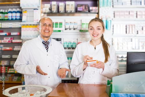 Pharmacist and pharmacy technician posing in modern farmacy