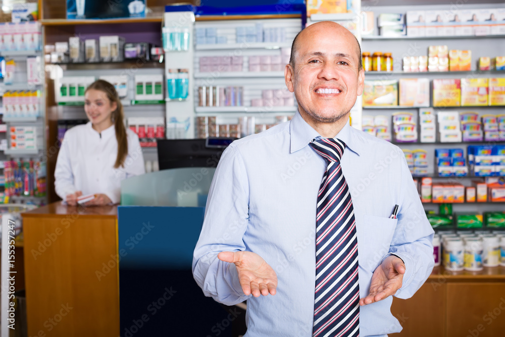 Pharmacist and client in pharmacy .