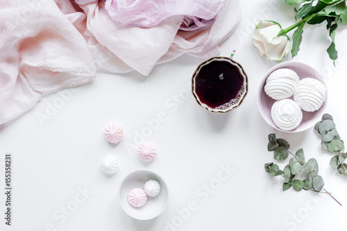 woman lunch with marsh-mallow and flowers soft light on white table background flat lay