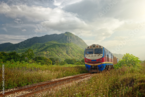 Train passing at sunset against the background of mountains