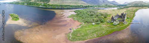The ruins of historic Kilchurn Castle and jetty on Loch Awe photo