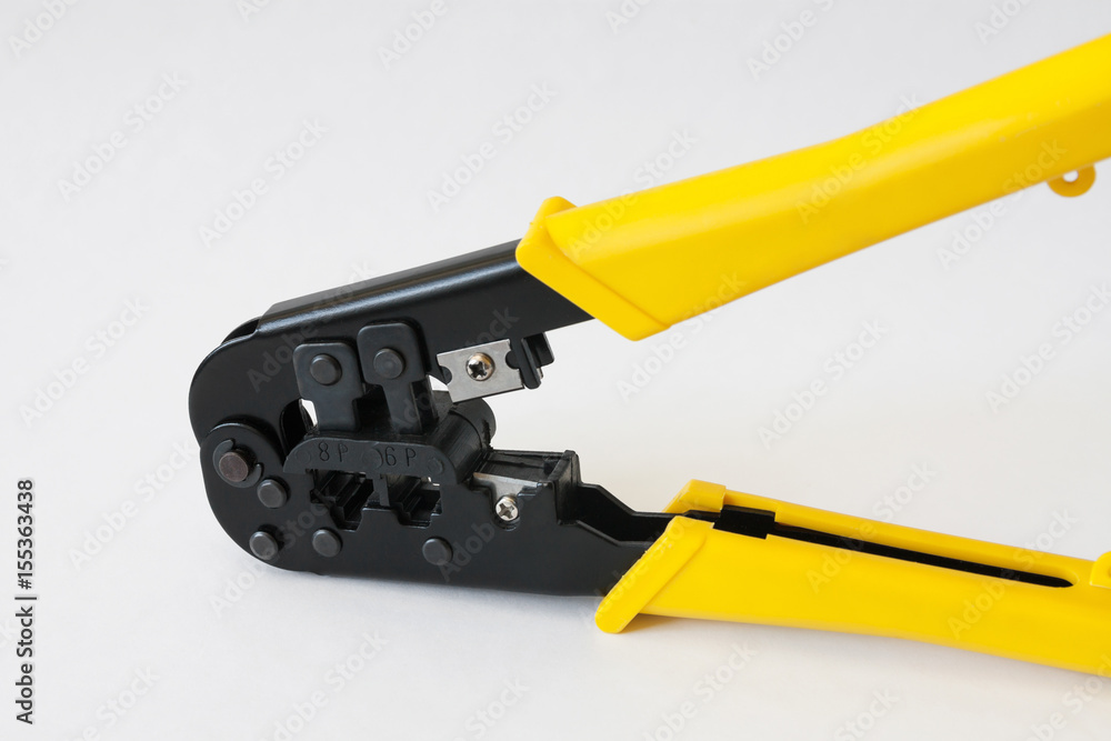 Crimping tool with yellow handles on white background. Crimping pliers closeup Crimping tool with yellow handles on white background. Crimping pliers closeup