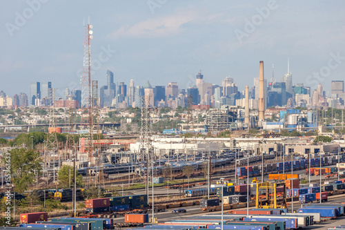 Cargo shipping containers with New York City view in background.