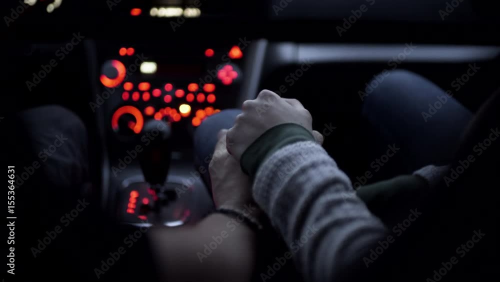 Male Driver And Female Passenger Hold Hands In Moving Car Male Driver And Female Passenger Hold Hands In Moving Car