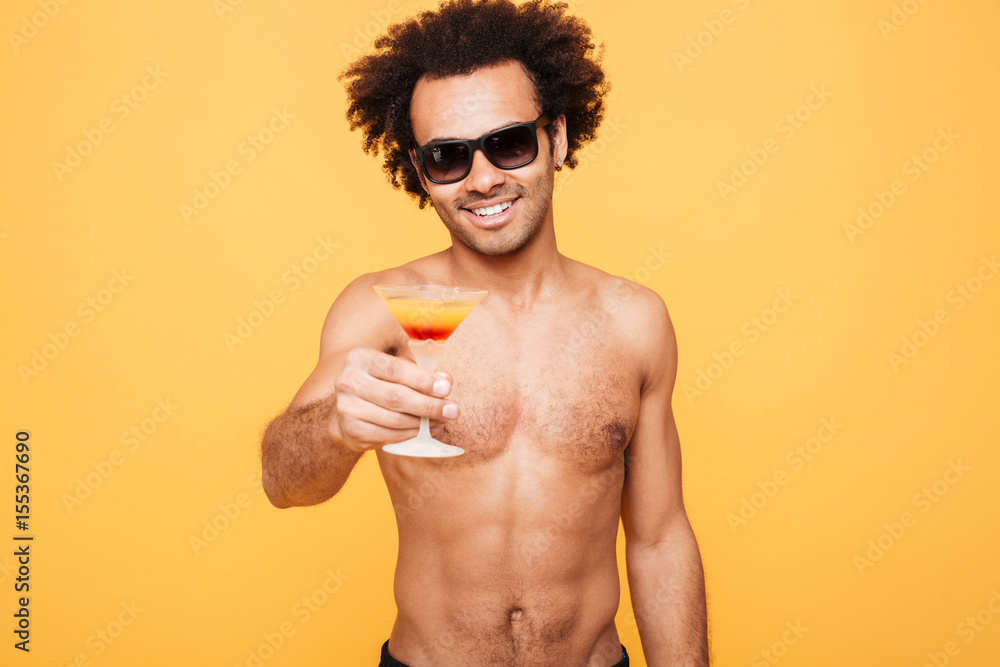 Young smiling african man holding cocktail. Young smiling african man holding cocktail.
