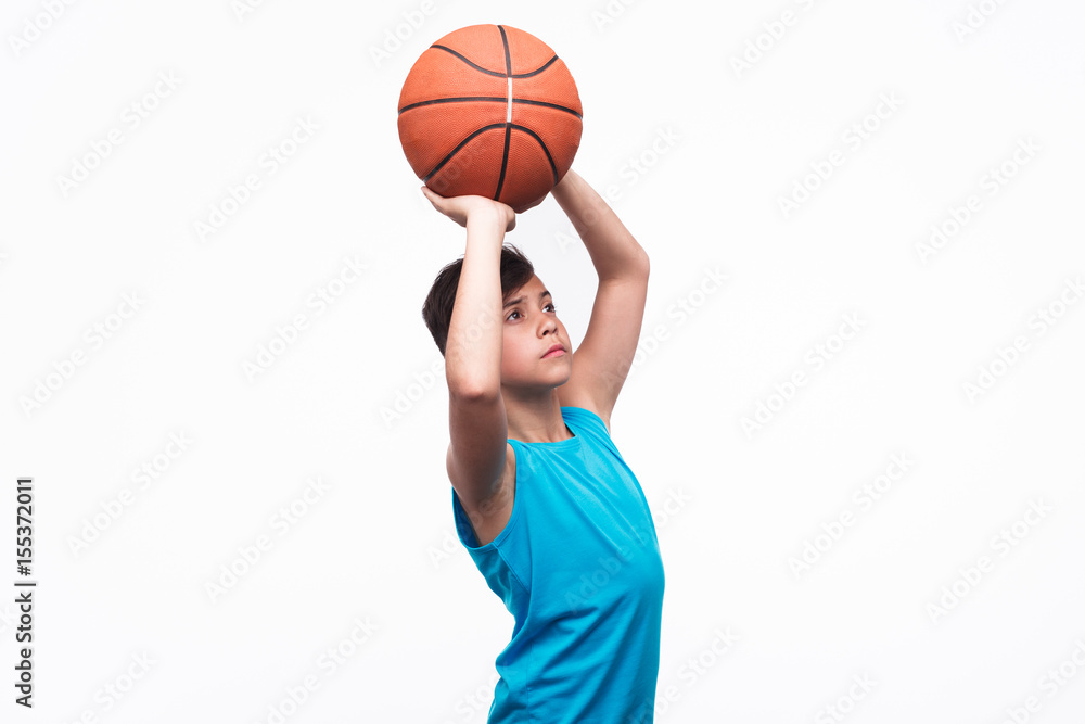 Young boy throwing basket ball