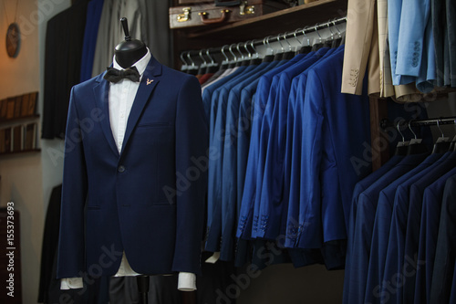 Elegant male mannequin presenting luxury suits tuxedo and male fashion accesories