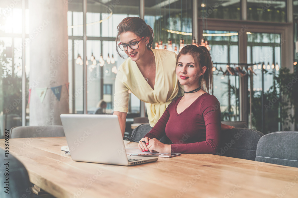 Two young businesswomen working.Teamwork.Girls blogging,working,learning online.Online education,marketing. Instagram filter. Two young businesswomen working.Teamwork.Girls blogging,working,learning online.Online education,marketing. Instagram filter.
