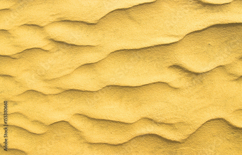 closeup of sand pattern of a beach in the summer.