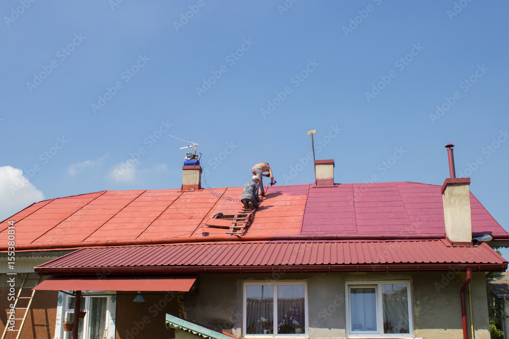 Man paints roof