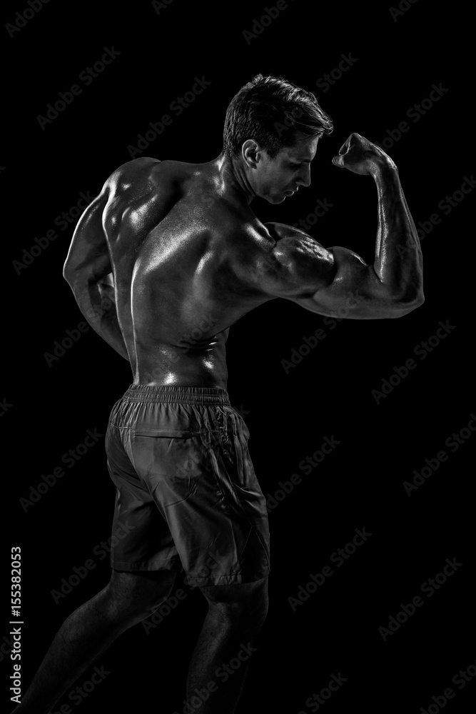 Strong Athletic Man Fitness Model posing back muscles, triceps o Strong Athletic Man Fitness Model posing back muscles, triceps o