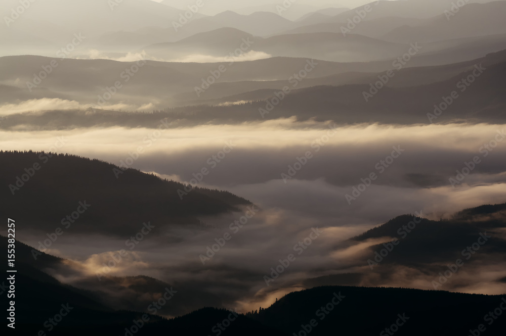 Fototapeta premium Mountain landscape at dawn with fog and tonal perspective.