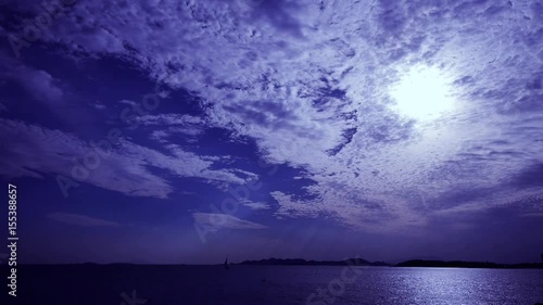 night clouds,moon light reflect on sea skyline.