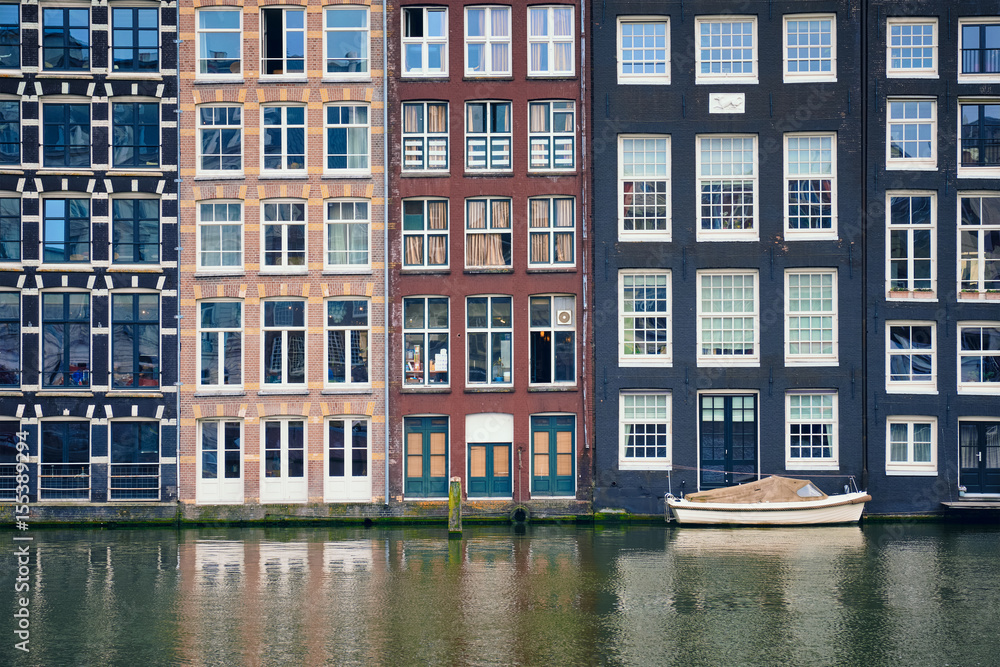 Amsterdam canal Damrak with houses, Netherlands