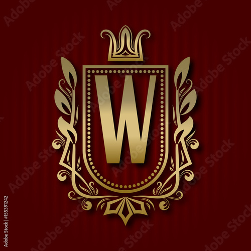 Golden royal coat of arms in medieval style. Vintage logo with W monogram.