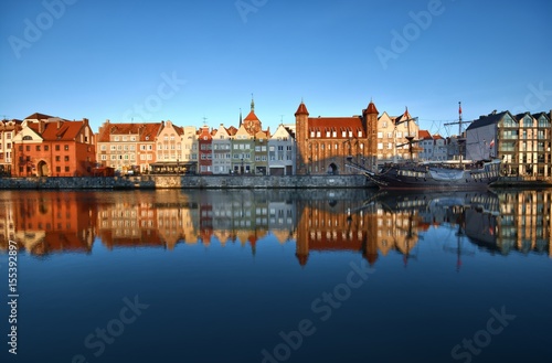 Caravel moored by Long Embankment on Motlawa River in the Old Town of Gdansk  Poland at sunrise. Straganiarska Gate in the center