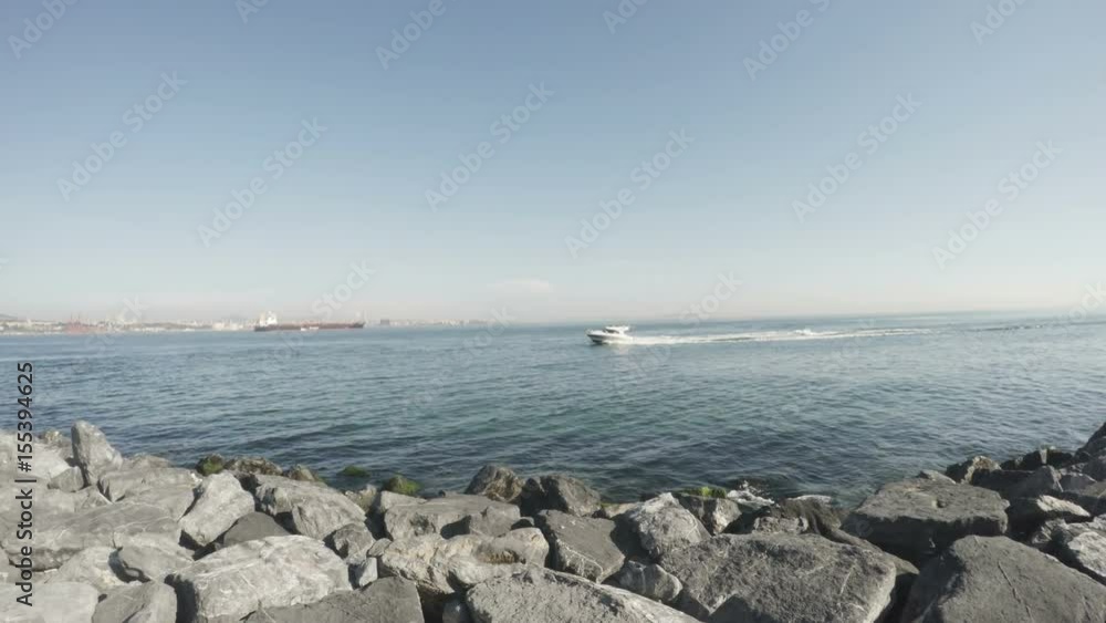 Boat floating on the turquoise colored waters. Turkey.