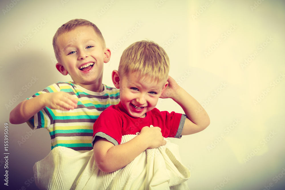 Two little boys siblings playing with towels Two little boys siblings playing with towels