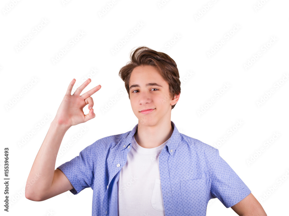 Happy teenager gesturing OK sign and smiling. Student in blue shirt, isolated on white background Happy teenager gesturing OK sign and smiling. Student in blue shirt, isolated on white background