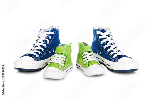 Two pair of a modern sport shoes for adult and kid.