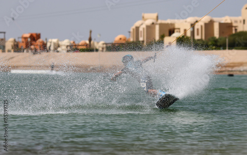 Wakeboarding sportsman on the slider in the cable park, water sports © yanamavlyutova