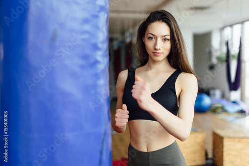 Young girl shnok to the punchball on gym background © Serhiy Hipskyy