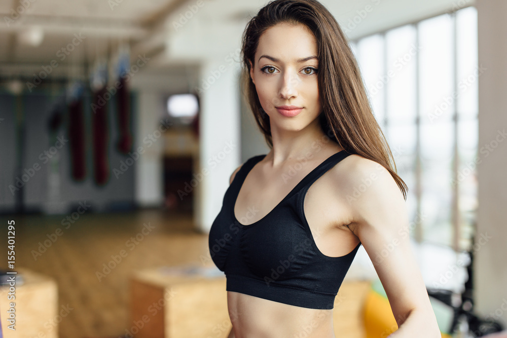 Girl do her exersice with barbell and smile to camera