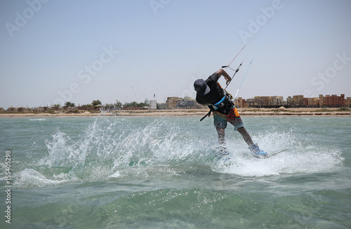 Kite sportsman riding in the crystal water, kiteboarding water sports, active lifestyle, blue lagoon kite spot, Egypt
