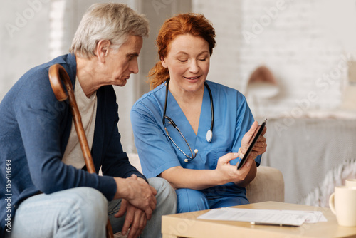 Photography Joyful excited nurse explaining something to her patient