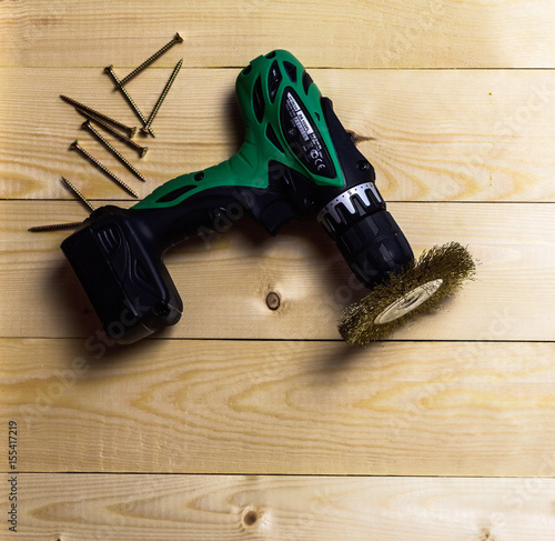 Screwdriver, nails and meter on wooden background photo