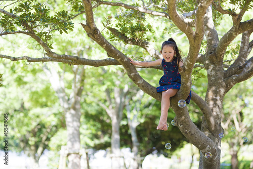 Little girl climbing a tree