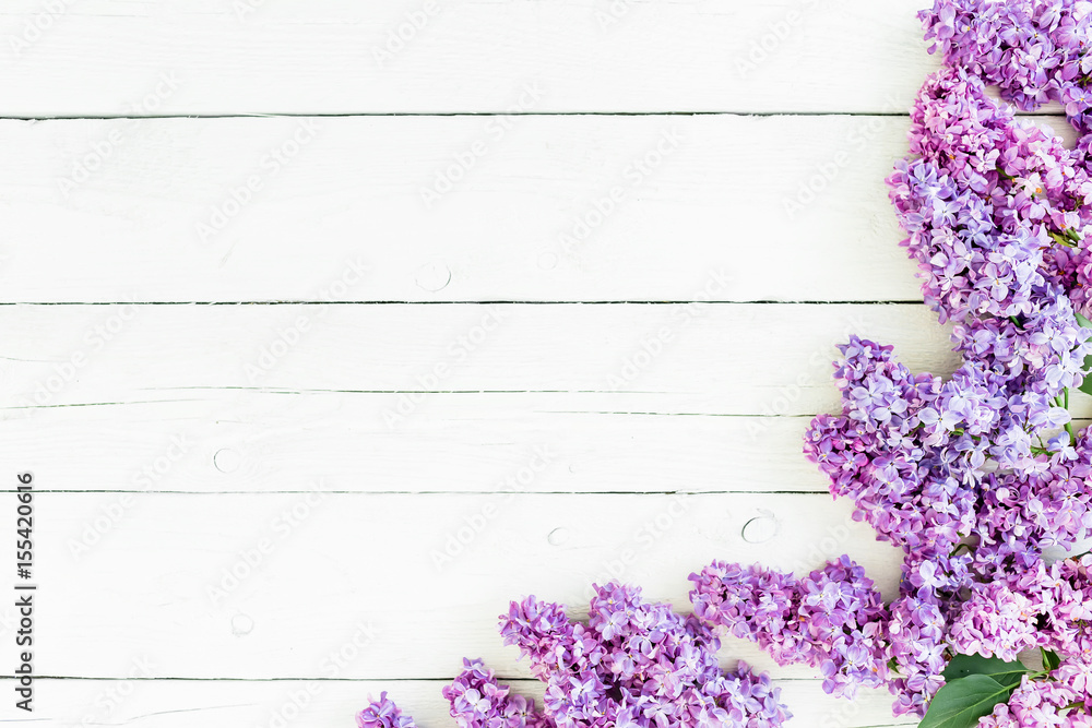 Floral pattern of lilac branches and petals on rustic background. Flat lay, top view. Spring flowers Floral pattern of lilac branches and petals on rustic background. Flat lay, top view. Spring flowers