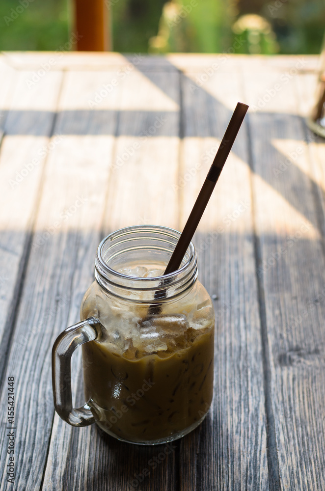 Straw in glasses of coffee put on wooden table Straw in glasses of coffee put on wooden table