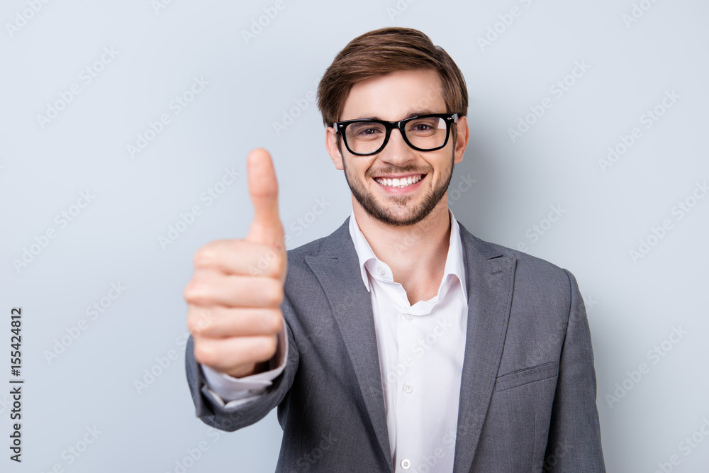 Successful excited bearded young guy in glasses and formal wear is standing isolated on a pure background Successful excited bearded young guy in glasses and formal wear is standing isolated on a pure background