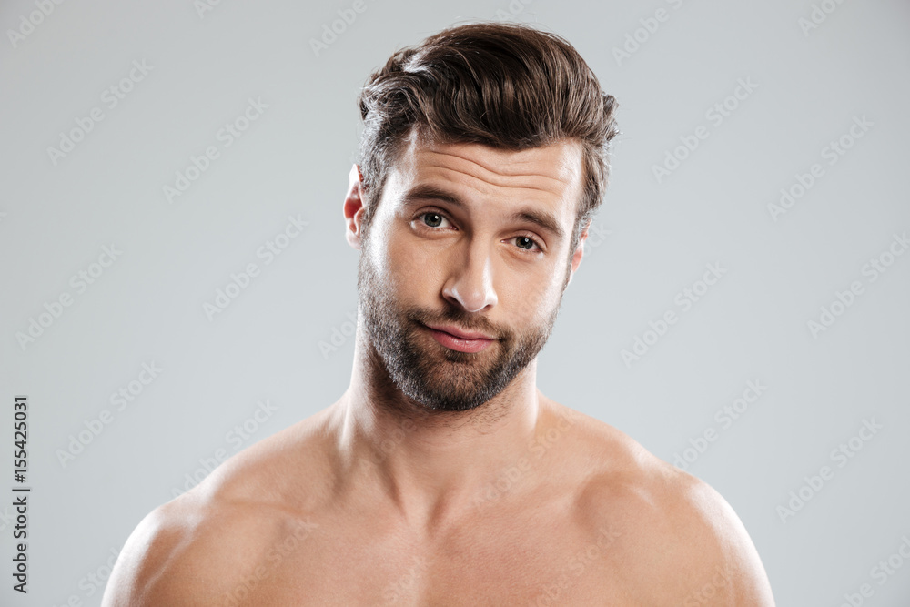 Portrait of a handsome doubtful man with naked shoulders Portrait of a handsome doubtful man with naked shoulders