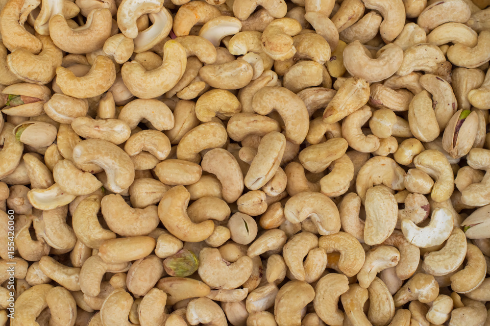 Cashews rich in heart friendly fatty acids. Healthy food. Cashew nuts as food background. Top view. Close-up Cashews rich in heart friendly fatty acids. Healthy food. Cashew nuts as food background. Top view. Close-up