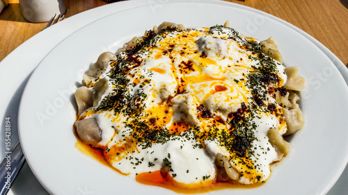 Turkish Manti Manlama with yogurt and fried butter sauce photo