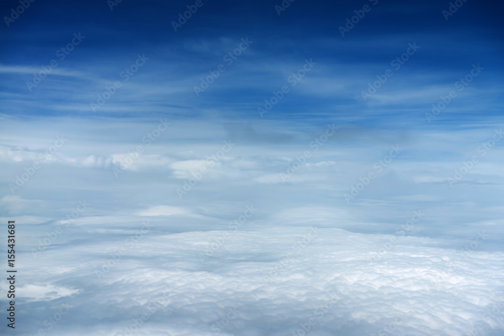 White clouds and blue sky view from airplane window. Beautiful cloudscape from sky aerial view. Beauty of nature view from above the sky and clouds.