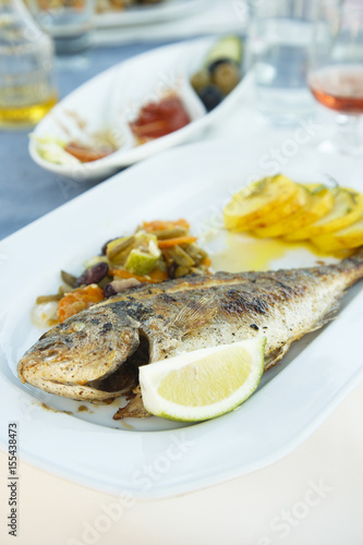 Grilled fish, served with vegetables and potato