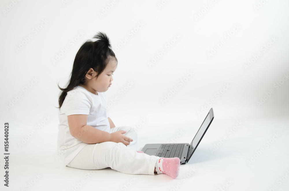 Asian child playing on computer laptop Asian child playing on computer laptop