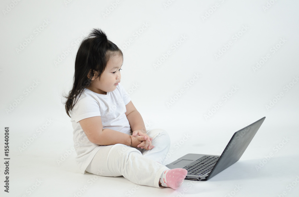 Asian child playing on computer laptop Asian child playing on computer laptop