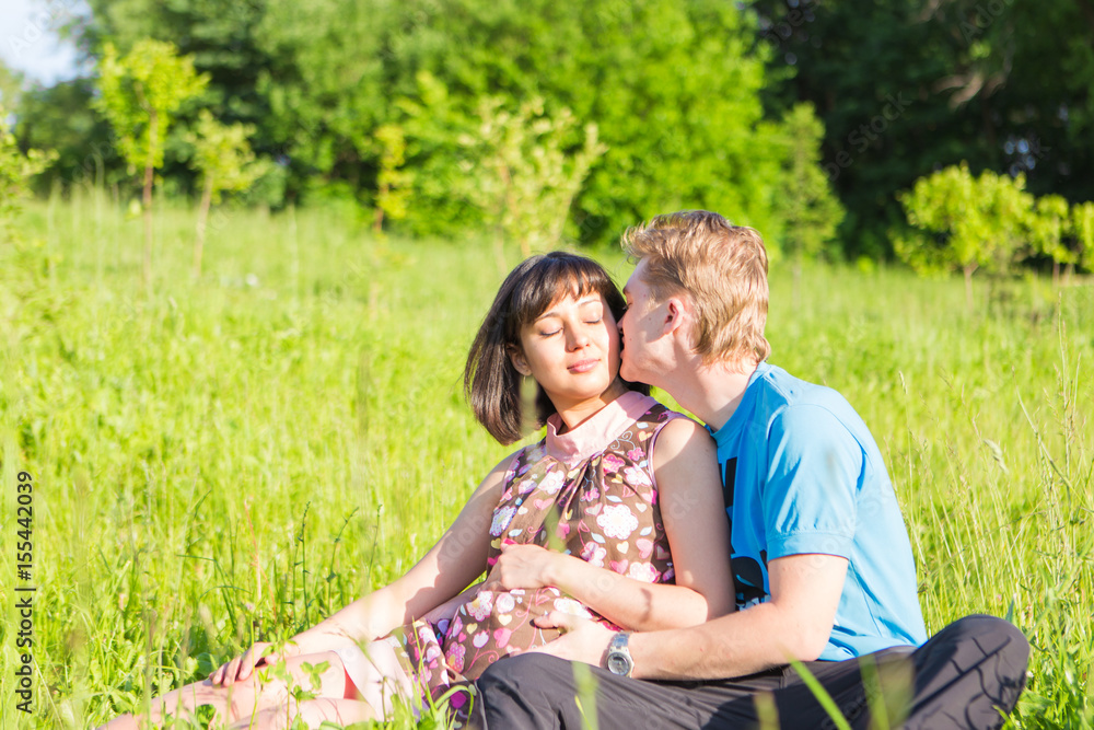 Fototapeta premium Happy pregnant woman and her husband in the park.