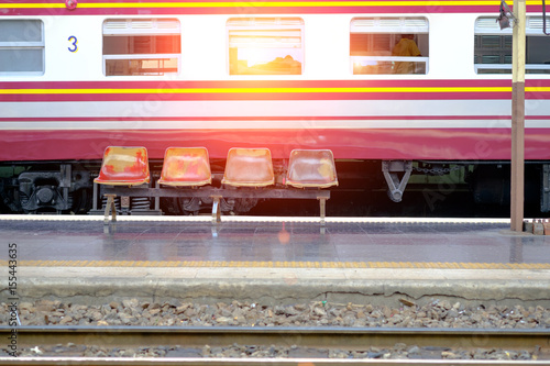 empty chair in central  Bangkok Railway Station  with Diesel train background. photo